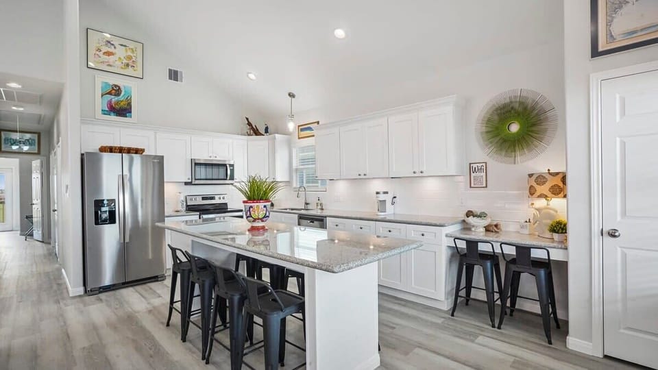 Gourmet kitchen that host seating for 10, work space, and appliances.