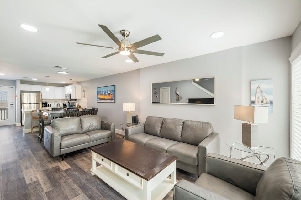 Relax in your spacious living area with comfortable leather seating, perfect for unwinding after exploring the coast.