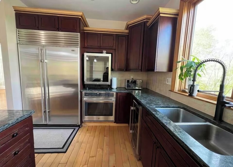 Fully equipped huge kitchen with island and seating subzero fridge and freezer