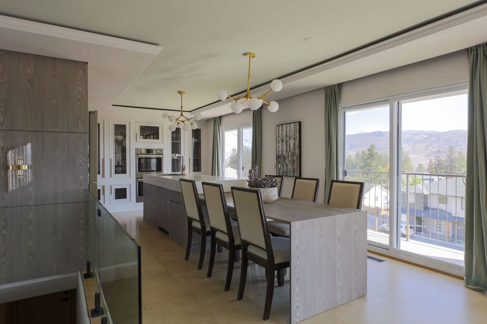 Kitchen island and dining area with lake, mountain view, seating 6 to 7