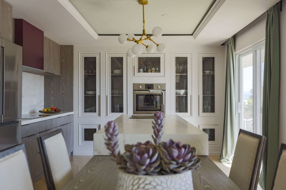 Kitchen with double oven, microwave, induction stove, fridge, dishwasher, hood