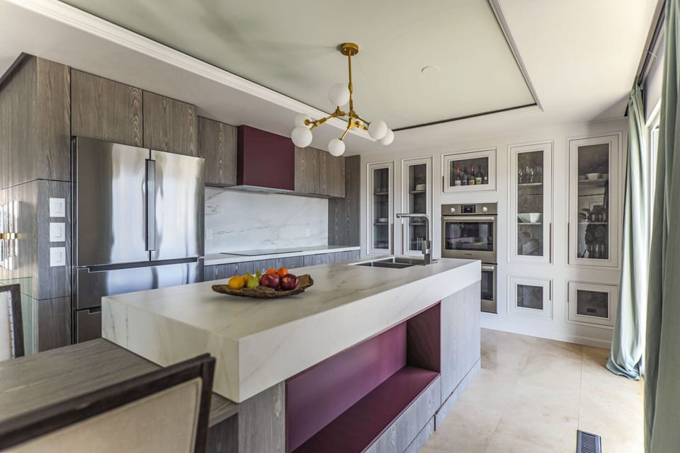 Kitchen with double oven, microwave, induction stove, fridge, dishwasher, hood
