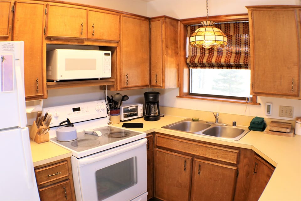 Your fully equipped kitchen has everything you need to prepare meals—stove, microwave, coffee maker, and plenty of counter space for cooking together.