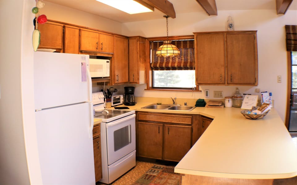 Your fully-equipped kitchen features warm wood cabinetry, ample counter space, and all the appliances you'll need to prepare your favorite meals during your stay.