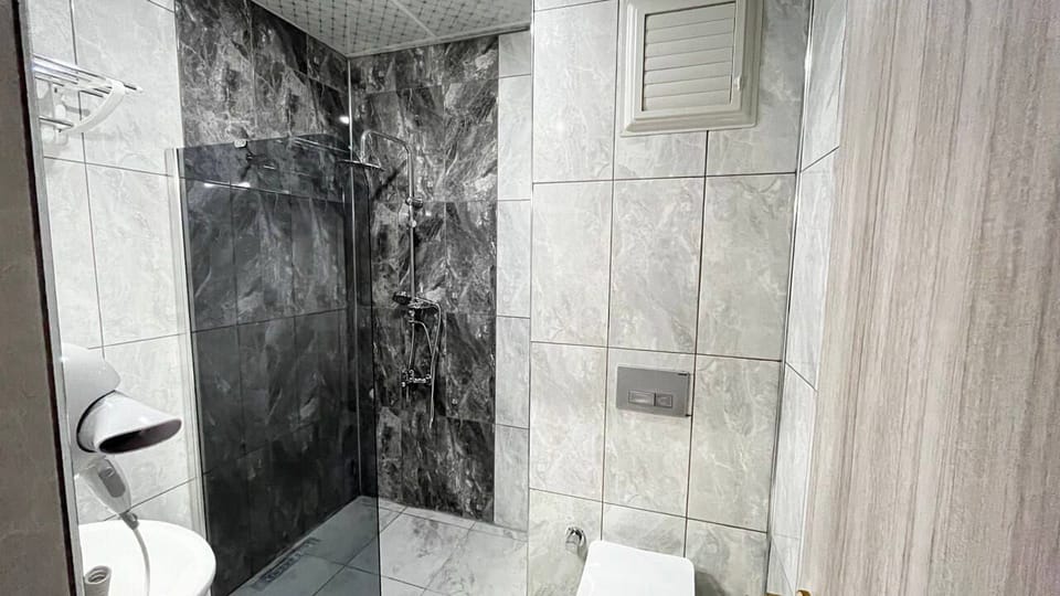 Shower, rainfall showerhead, hair dryer, towels