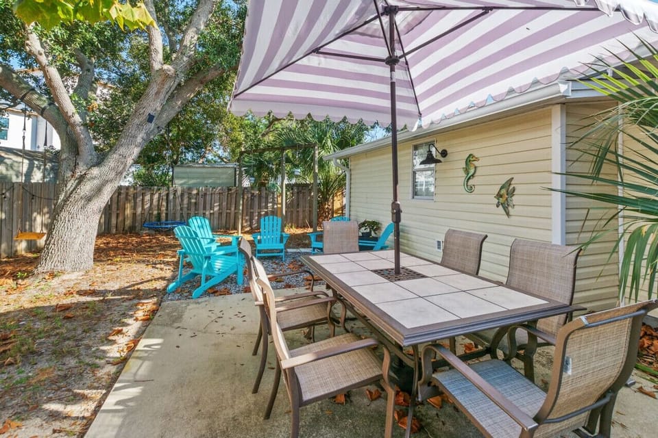 Awesome outdoor area. Features cornhole, Edison lights, dining table seating 6 with umbrella cover, and several Adirondack chairs!