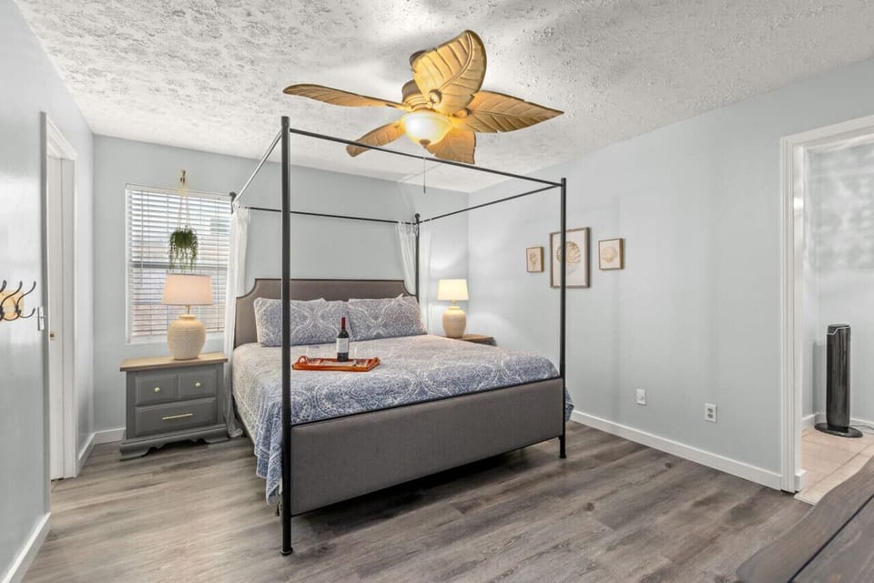 Spacious king bedroom featuring an attached en-suite, an additional full bed area, and a smart TV for your comfort and convenience.