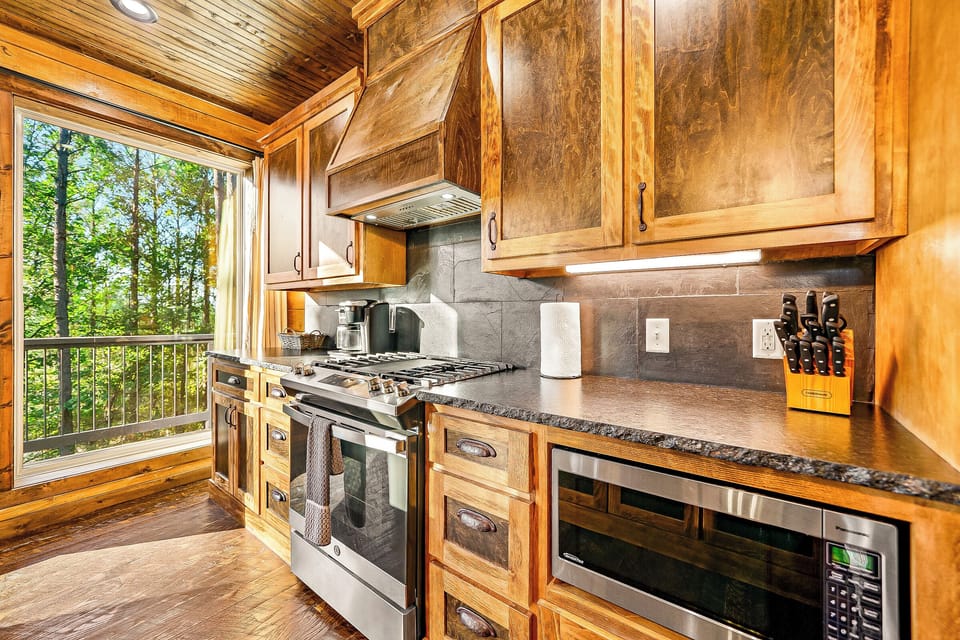 The kitchen is fully equipped with appliances, dinnerware, and cookware