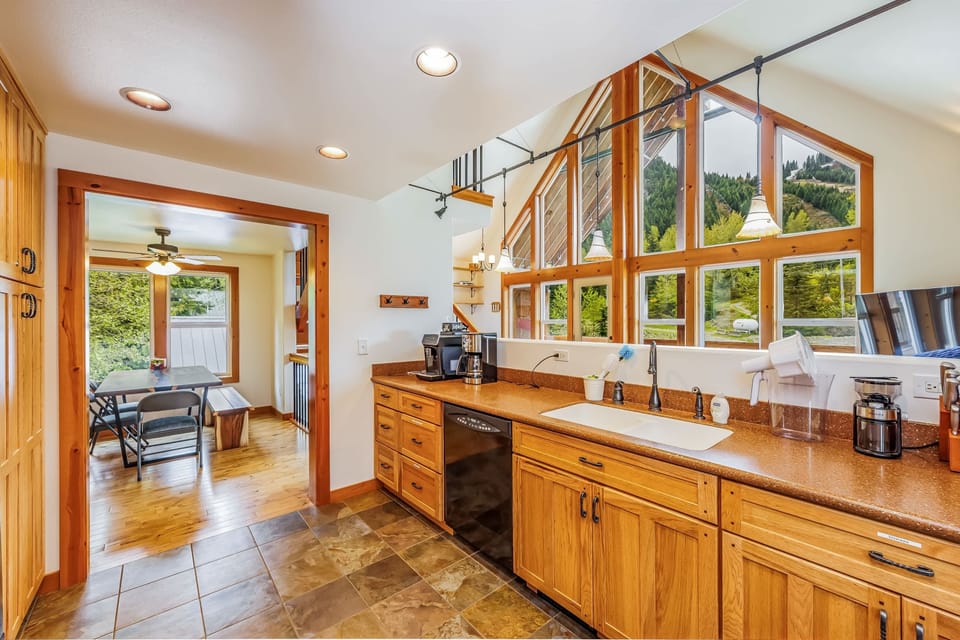 Spacious kitchen with modern appliances, ample cabinetry, and large windows offering abundant natural light and scenic views.