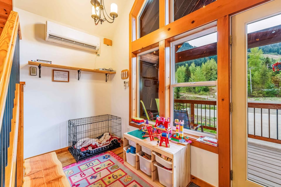 Play nook with a puppy crate and some toys for kiddos