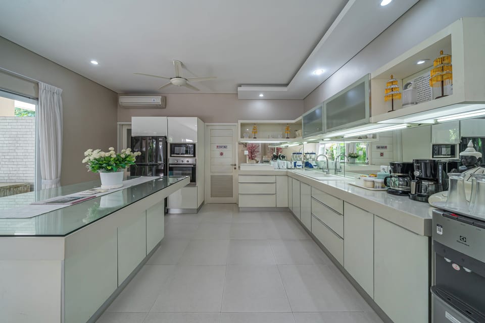 Villa | Private kitchen | Fridge, electric kettle, dining table