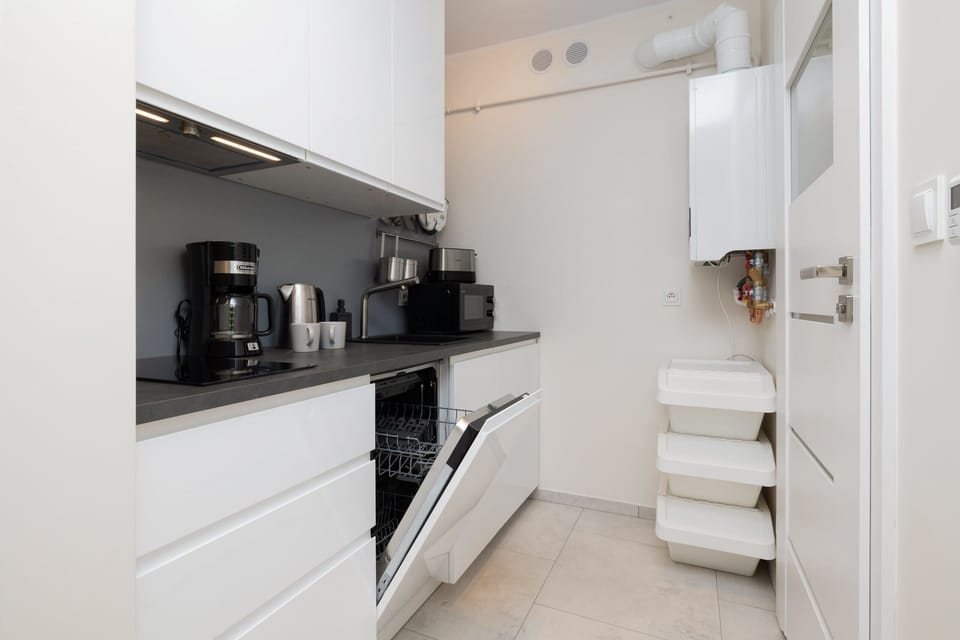 Kitchen angle focusing on the coffee machine and modern cabinets. 