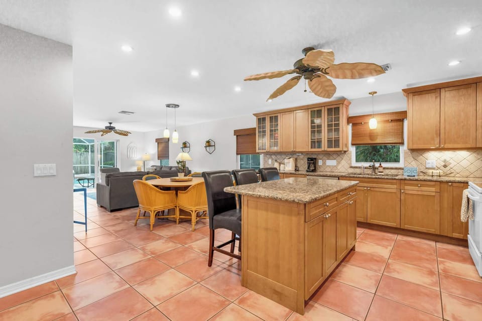 The kitchen is open and spacious and has granite counter tops and a large center island