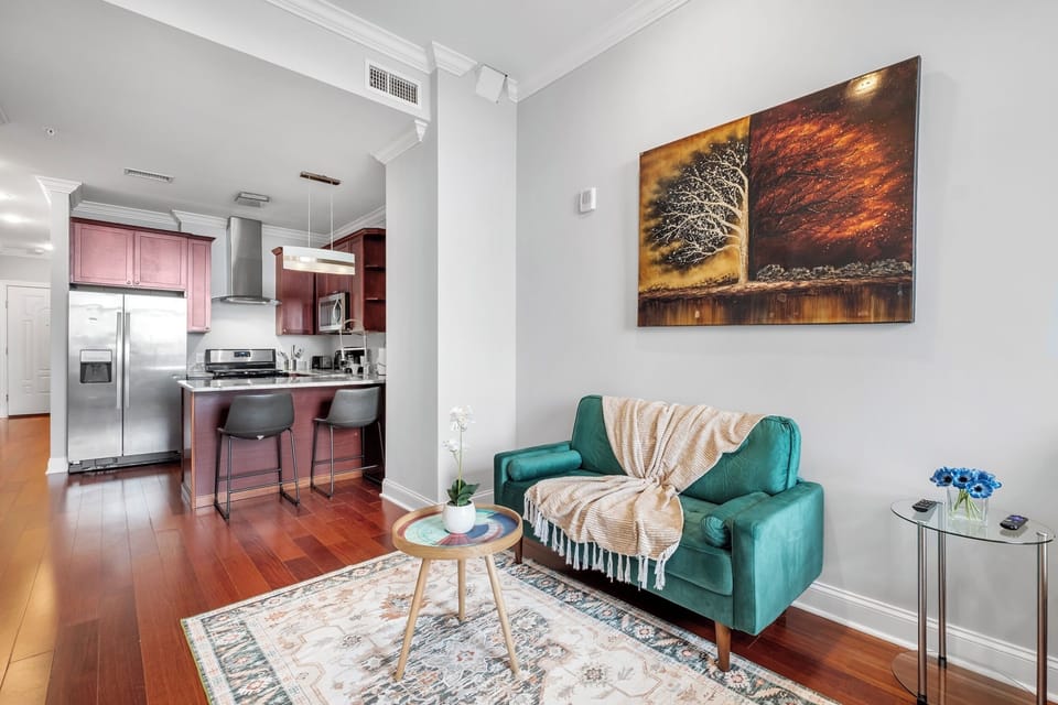  Bright living area with comfortable seating, large windows, and open layout.