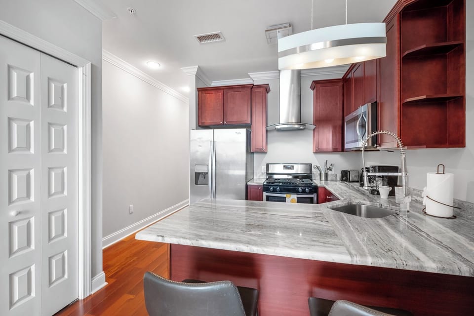  Kitchen equipped with  stainless refrigerator, full-size range, and complete cooking amenities.