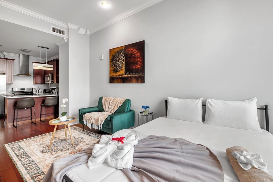 Bedroom space with plush bedding, decorative pillows, contemporary decor, and efficient layout.