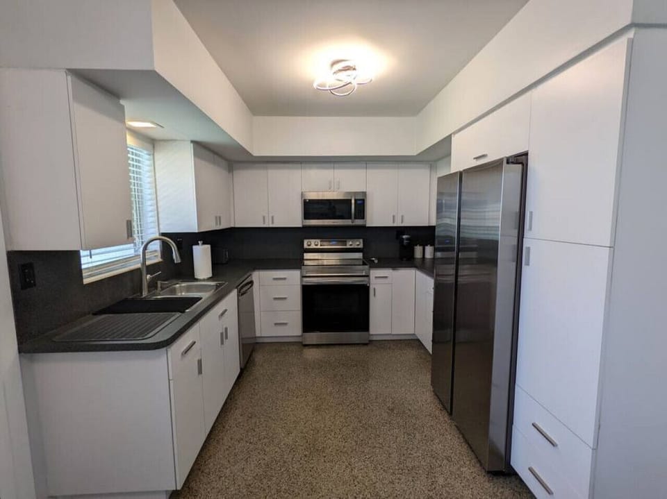 A nice modern feel from the fully equipped and furnished kitchen with all the major stainless steel appliances and small appliances needed to make your stay enjoyable. Coffee station with Keurig, French press, and tea.