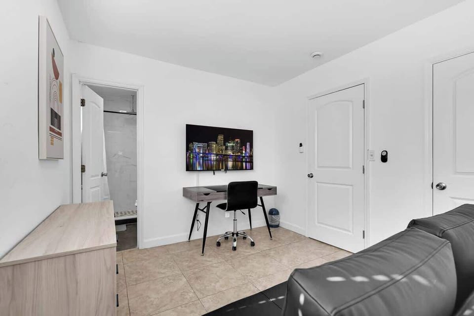 “Dedicated workspace with desk, monitor, and seating—ideal for remote work at your Airbnb getaway.”