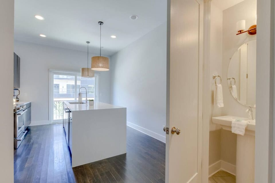 Stylish kitchen and bath area with modern fixtures and pendant lighting