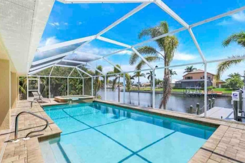 South facing wide cancel views! Heated pool, hot tub plenty of space to relax on large lanai. 3 chaise lounges chairs for sun bathing or napping in the shade. Table for 6. Fire table area w seating for 6.