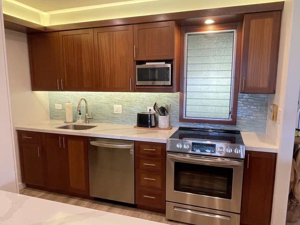 New quartz counters and glass tile backsplash