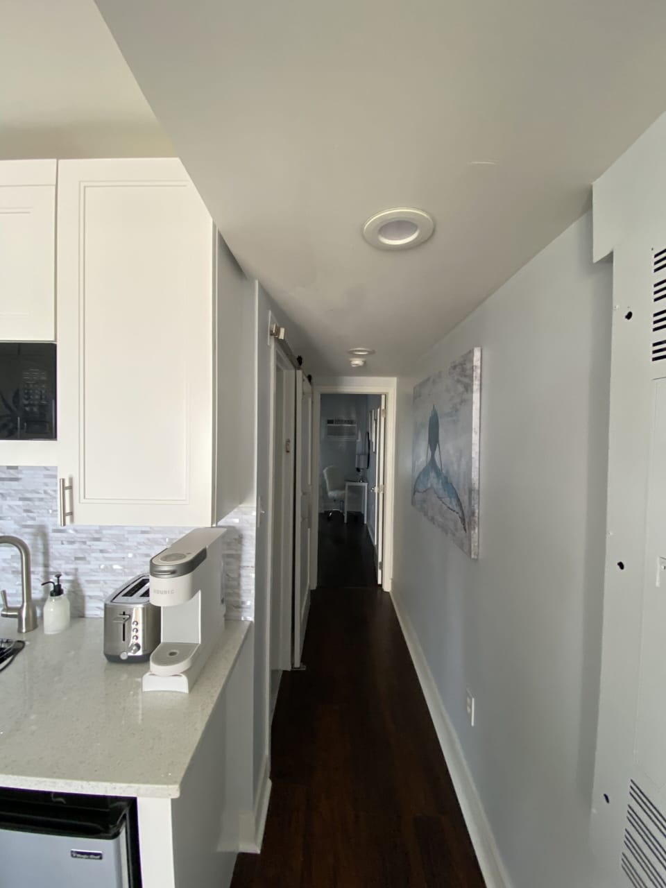 View of bedroom and bathroom from the living area. 