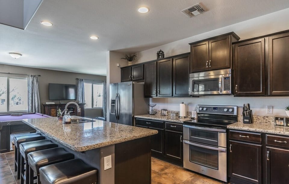 Generous Chef's kitchen with double oven, huge island and granite countertops.