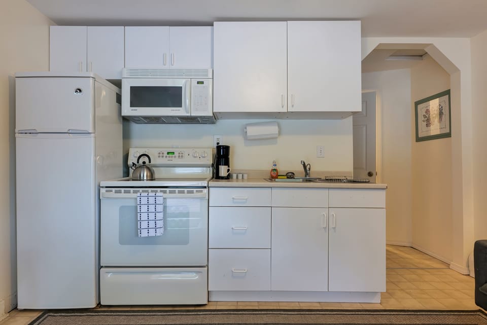 Kitchen with Full sized Refrigerator, Microwave, and Coffee Maker. 