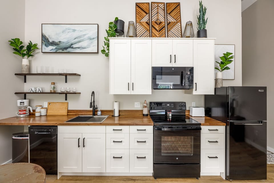 Fully equipped kitchen w/ full-size stove, fridge & island seating for easy meals at home.
