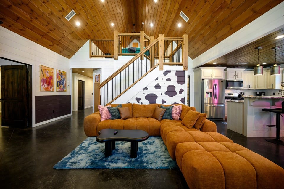 As soon as you enter, the living room greets you with rustic charm, cowboy accents, and groovy disco vibes – the perfect introduction to the Disco Cowboy Cabin!