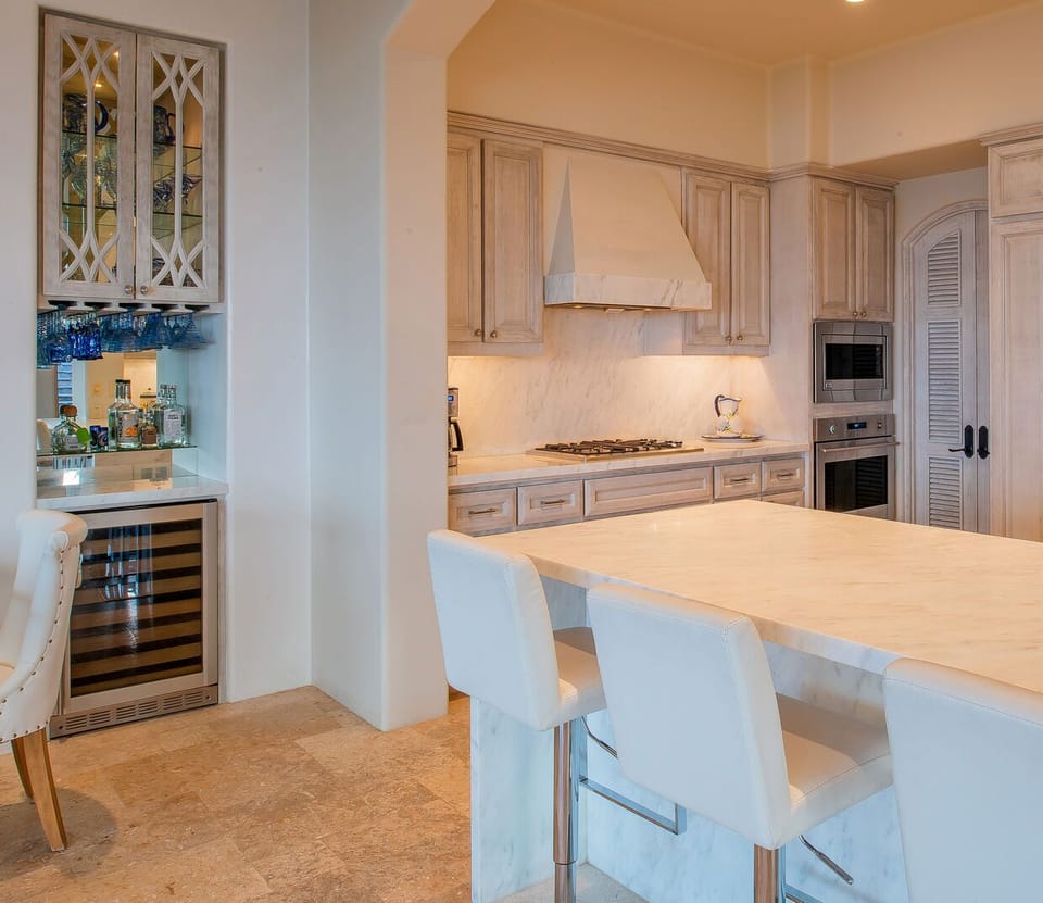 the kitchen of this Los Cabos Luxury Vacation Villa, complete with bar seating and stainless steel appliances.