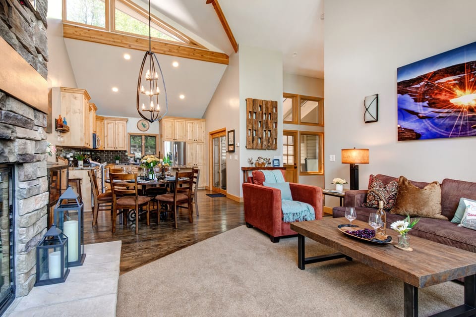Living Room with plush furnishings, wood-burning fireplace, smart TV, and private deck access