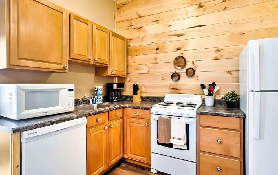 Mixing modern convenience with classic charm in our kitchen - the wood paneling and a well-stocked kitchen really makes the perfect combination!