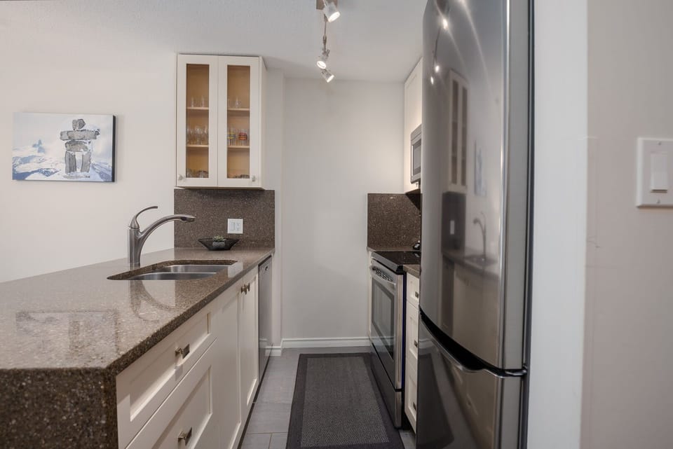 The fully equipped kitchen features modern appliances and everything you need to cook at home.
