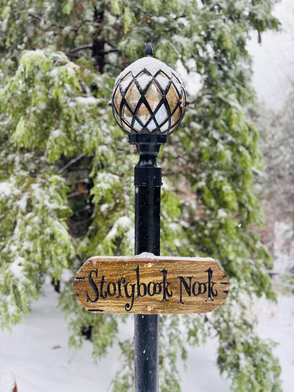 Storybook Nook sign after a powdery winter snowfall