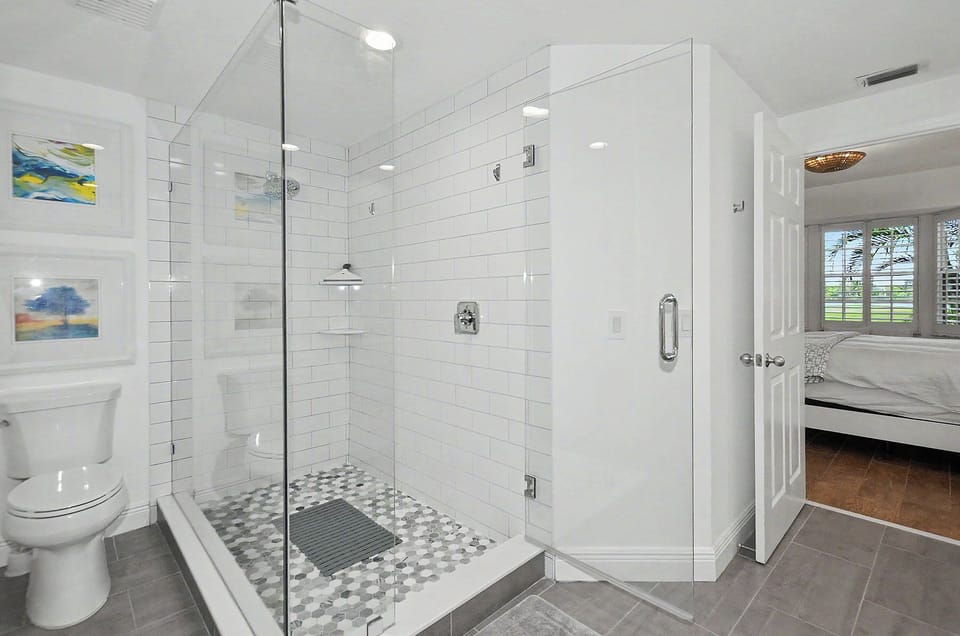Primary bathroom with glass enclosed shower.
