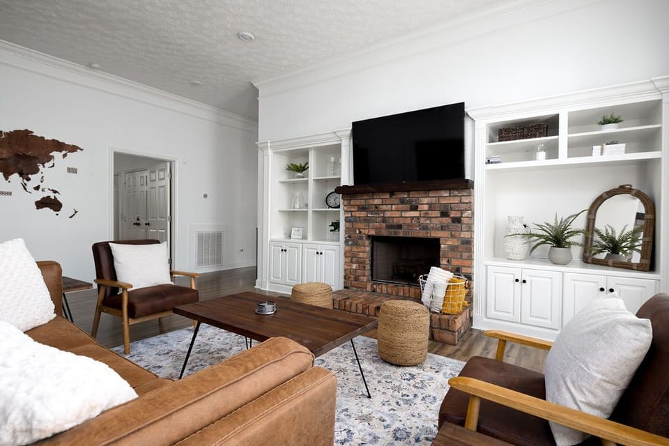 Inviting living room featuring built-ins, cozy seating and warm natural light