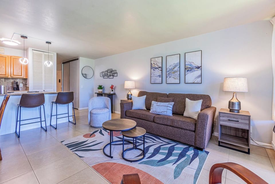 Step into your inviting living space, where a plush sofa and comfortable seating create the perfect spot to unwind after a day of adventure. Modern touches and thoughtful decor make this your home away from home.