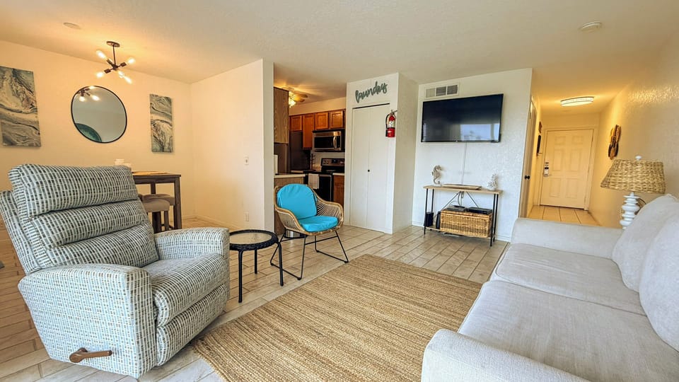Relax in your thoughtfully furnished living space with comfy seating, modern kitchen access, and entertainment center ready for memorable evenings.