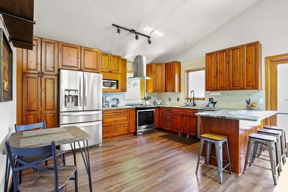 Kitchen: Stainless steel appliances, drip coffee maker, Keurig, Crockpot, cooking utensils, tableware