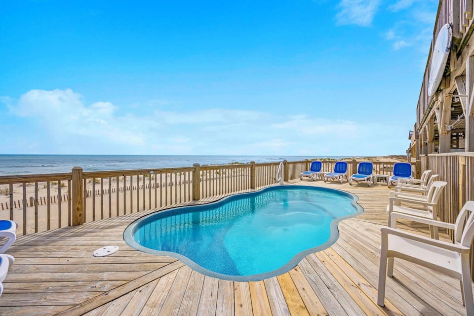 Your private oceanfront pool deck offers stunning sea views and direct beach access for the perfect coastal getaway.
