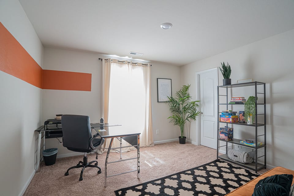 office: a desk and chair, a shelf with lots of games for you to enjoy 
