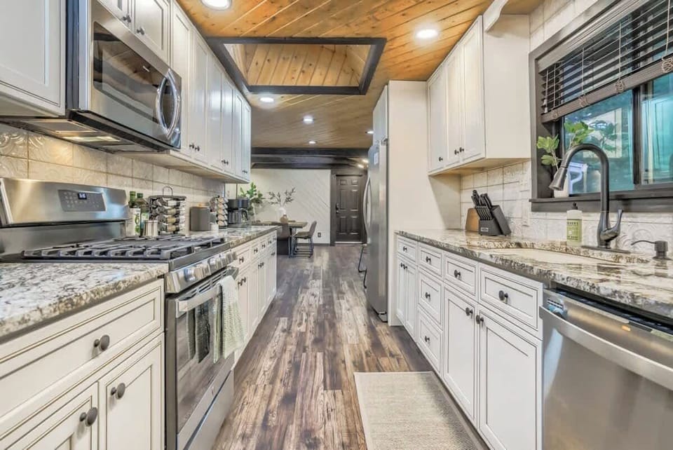 The fully stocked galley kitchen is just beckoning you to cook to your heart’s content! Enjoy the gas range and plentiful granite countertops for preparing your meals on!