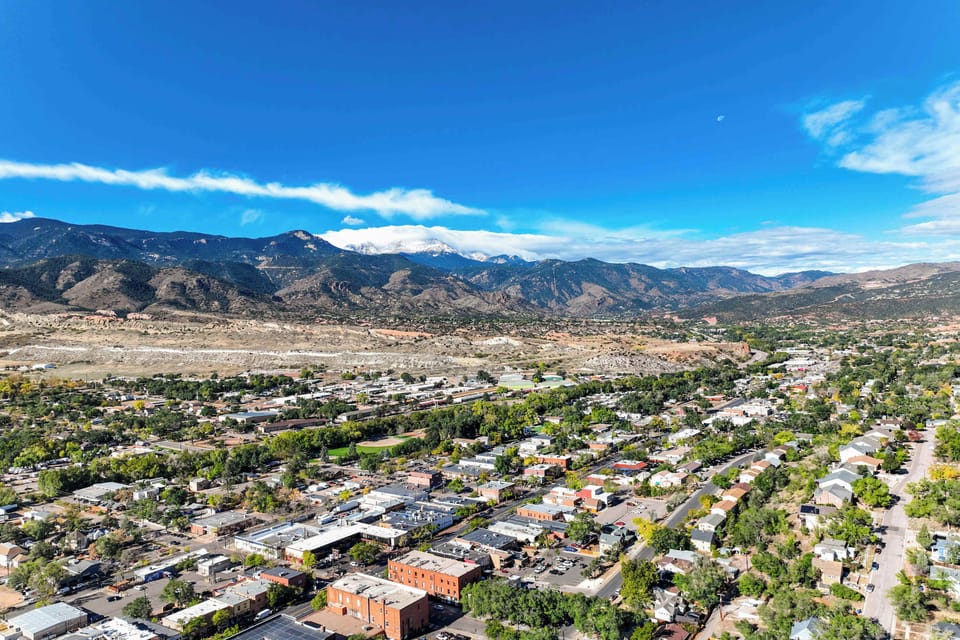 Stunning aerial view of Old Colorado City with the Rocky Mountains in the background, offering easy access to both urban attractions and outdoor adventures.