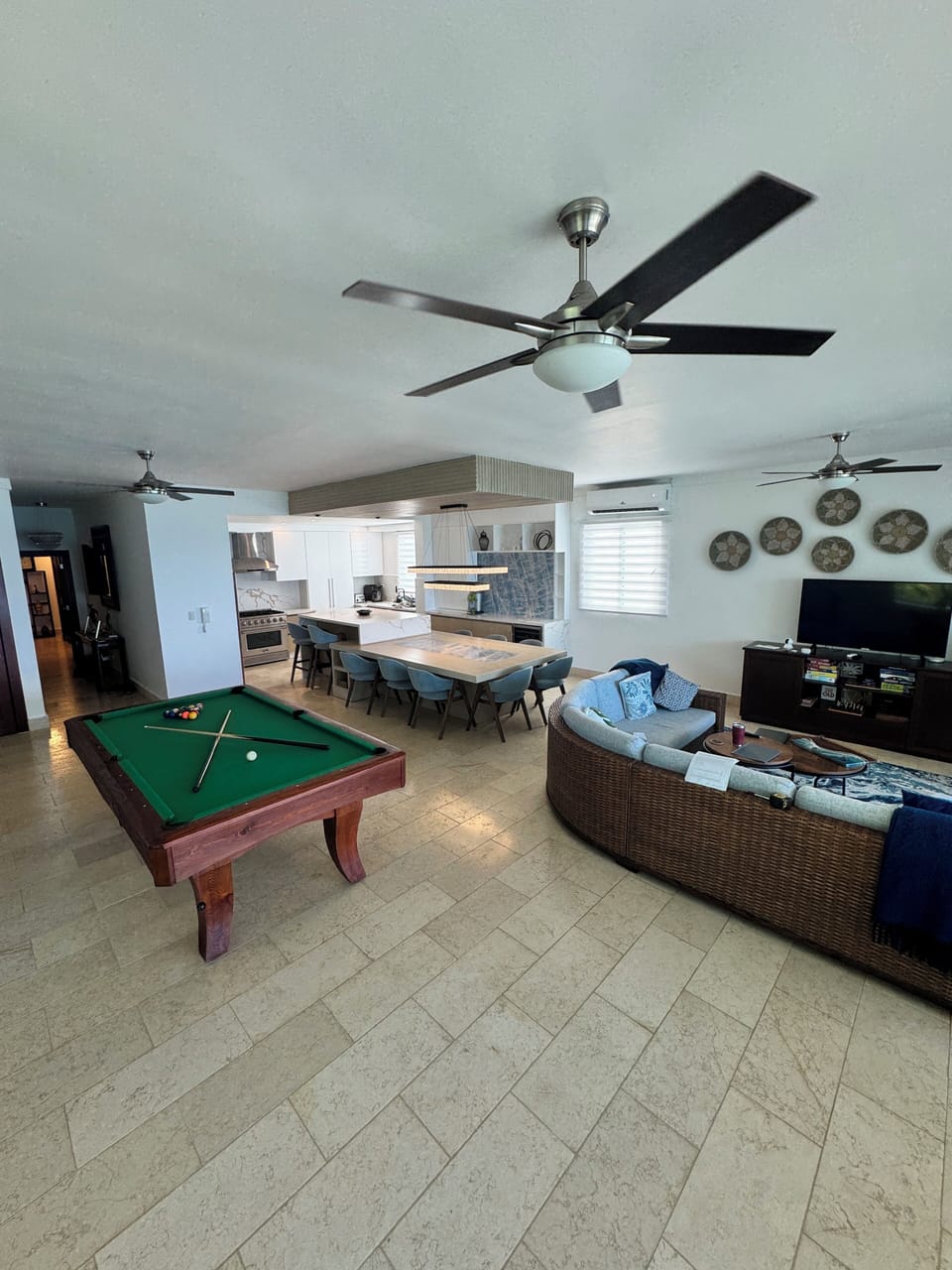 Main living area with ocean view, sectional seating, pool table, 