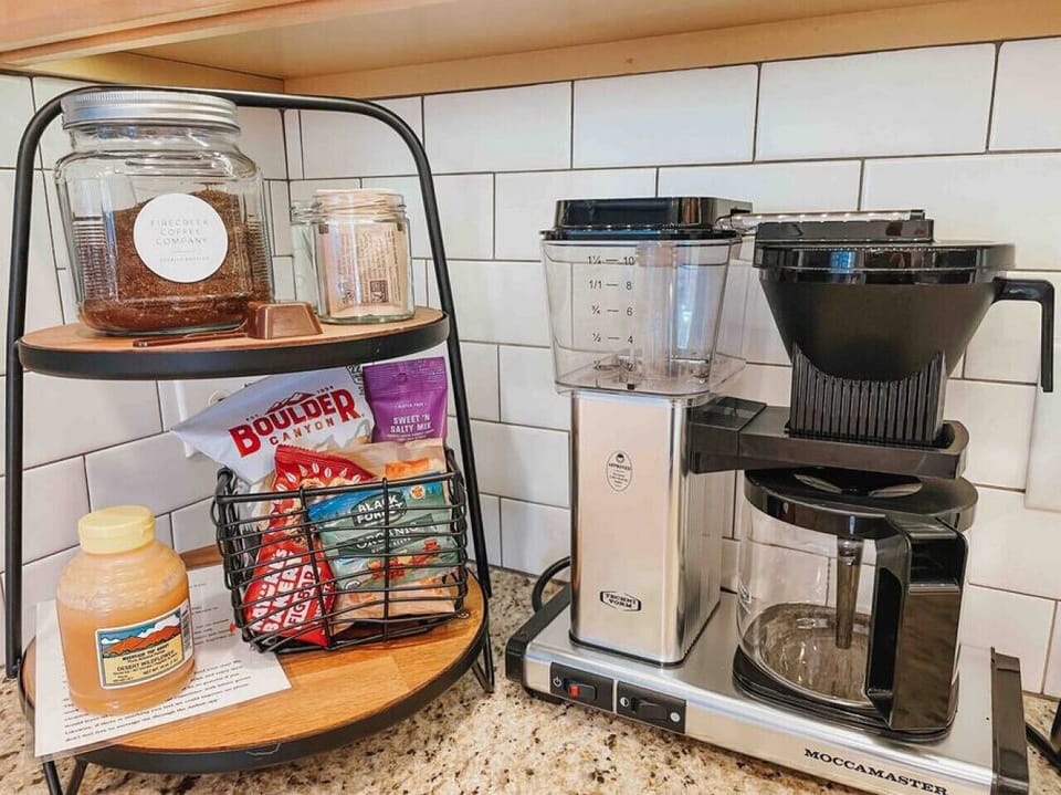 Tecnivorm Moccamaster high end drip coffee maker. Local coffee grounds, powdered creamer, & sweeteners provided