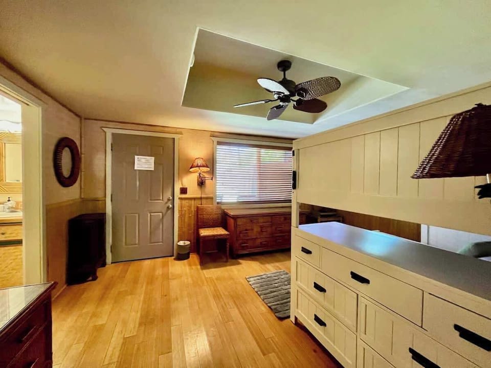 Bedroom 2 with full-sized bunk be and private bathroom and back door access.