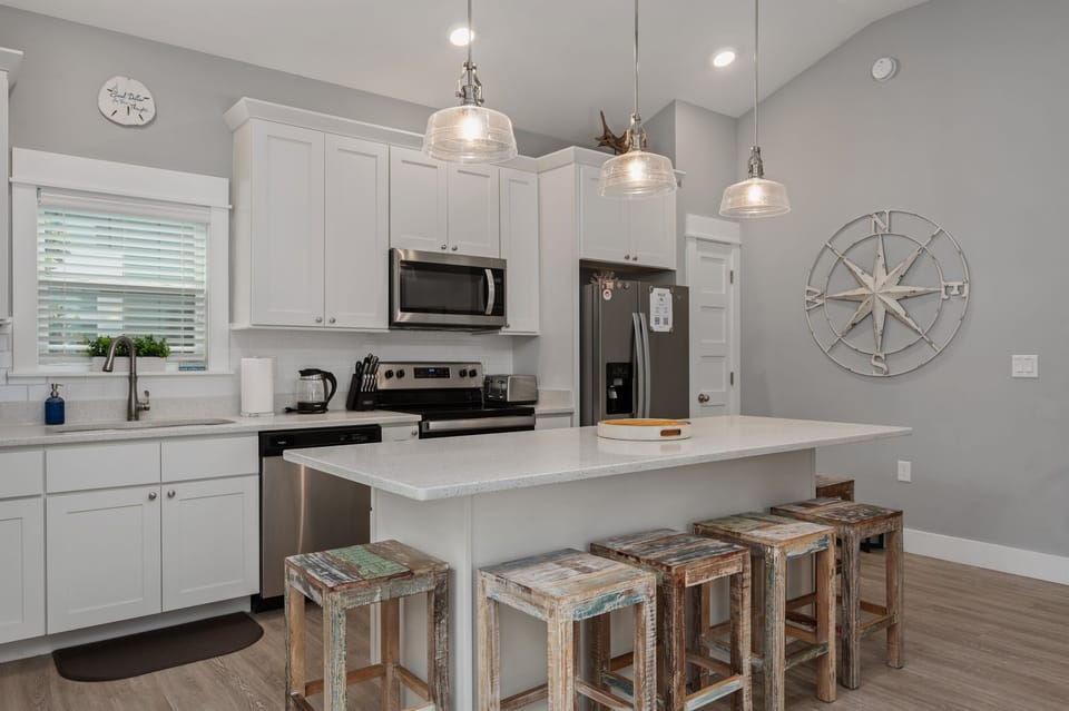 Beautiful open layout kitchen with island. Stone countertops and stainless appliances.