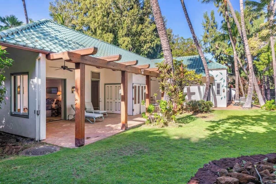 Two of four bedrooms open to trellised lanais