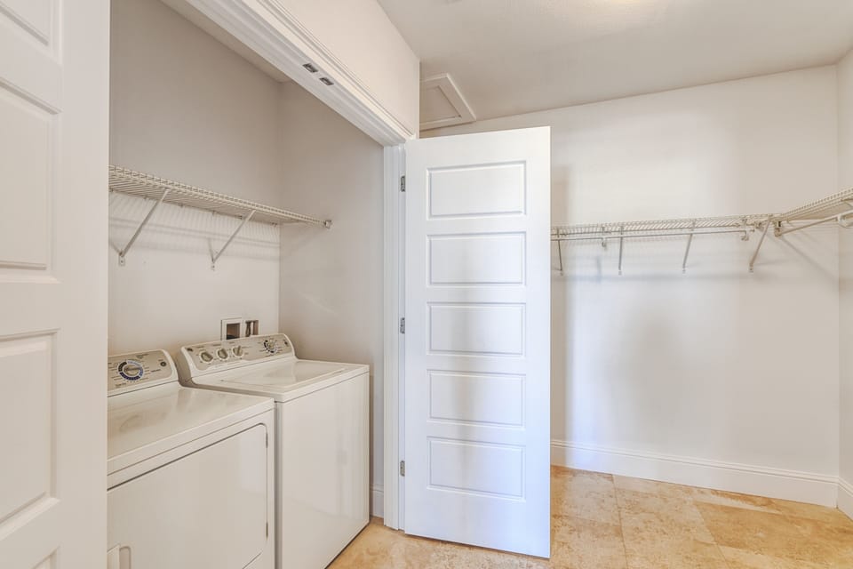 Washer and dryer in the closer of the primary bedroom.